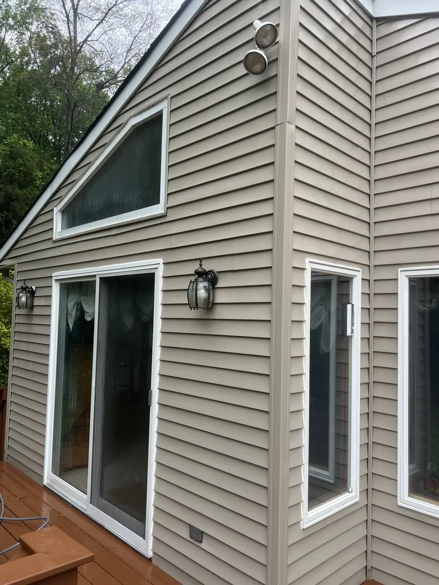 Clean siding and trim after AidPro soft-wash house washing