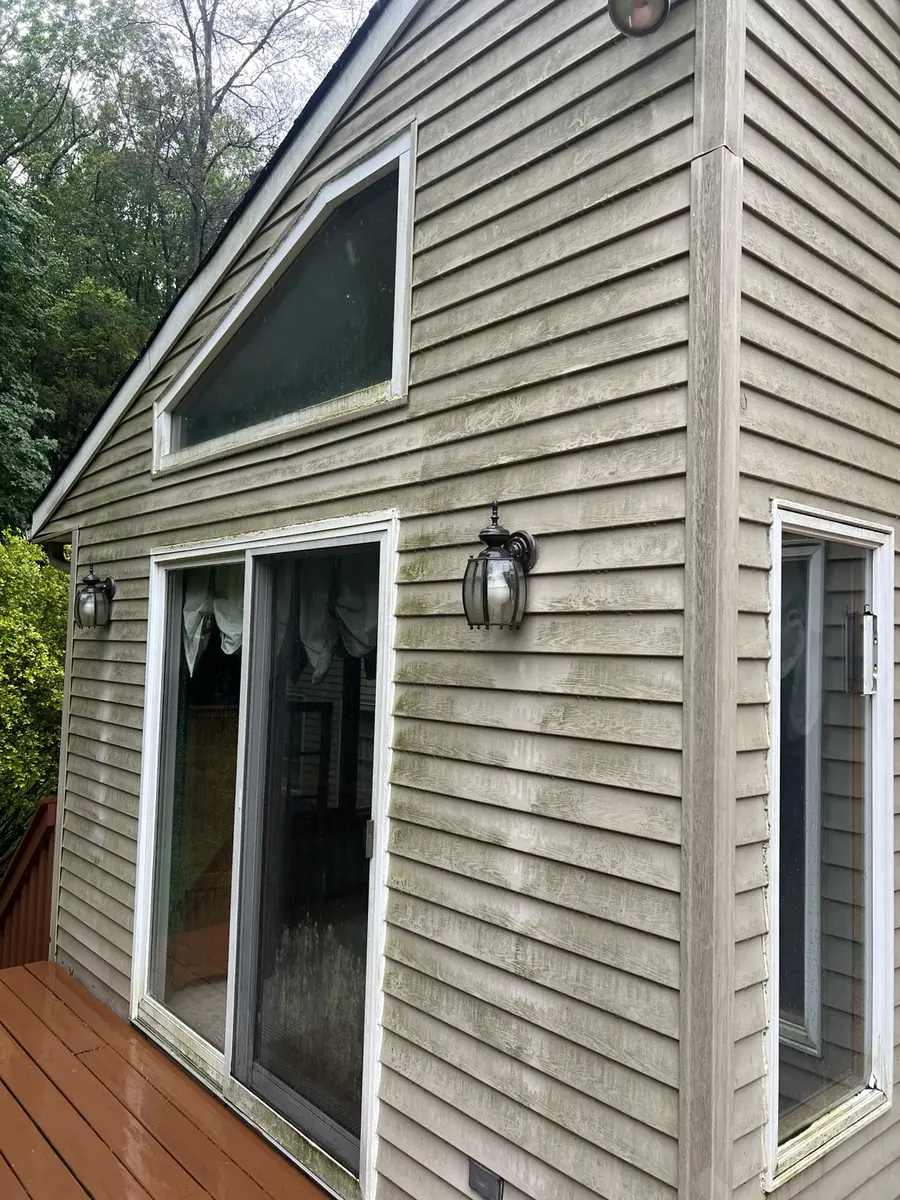Siding with algae and grime before AidPro house washing