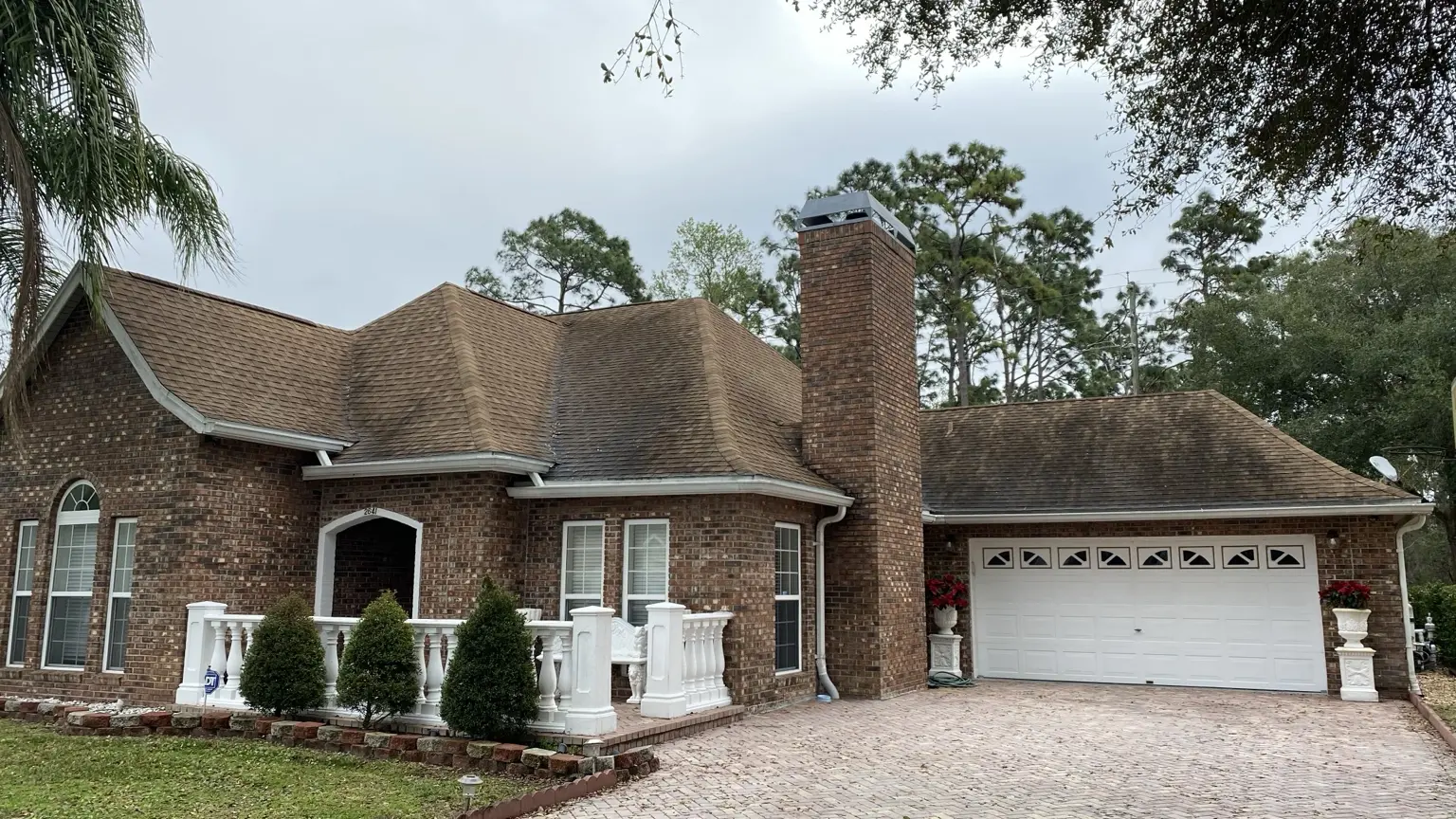 Roof with dark algae streaks before AidPro soft-wash roof cleaning